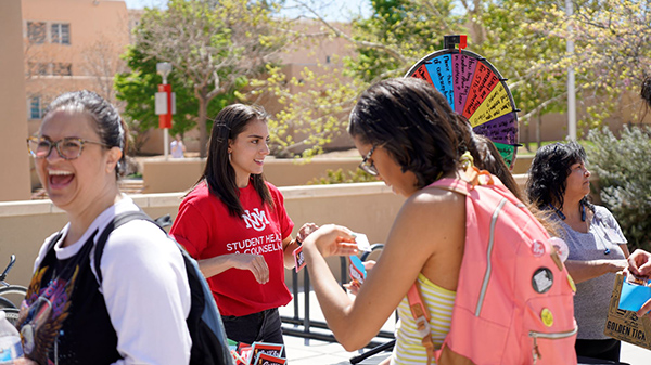 Students fill out raffle tickets and play games at the Condom-Mint Celebration.