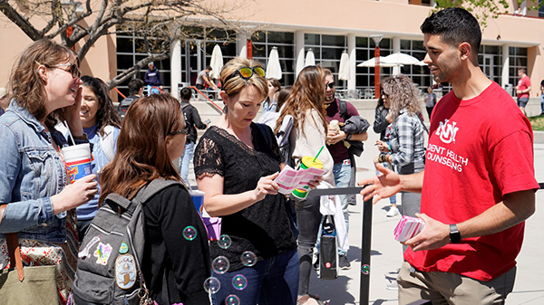 A SHAC student employee talks to other students about the Condom-Mint program.