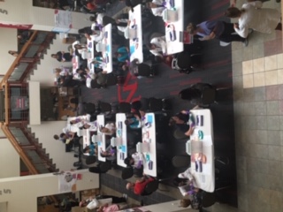 Tables with people are spread out at the SUB Atrium for flu shots.