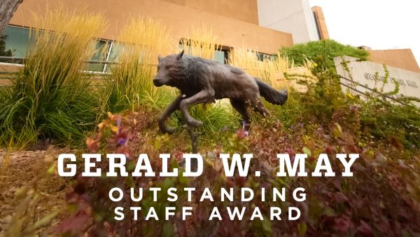 "Gerald W May Outstanding Staff Award" text is in front of a statue of a running wolf/lobo.