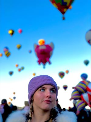 Olive Moss looks up at all the balloons at the NM Balloon Fiesta.