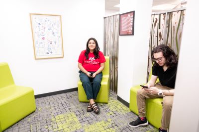 Two students are sitting the Counseling Waiting Area.