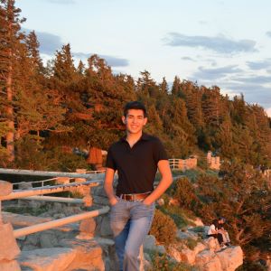 Joseph Baros stands in front of a mountain backdrop.