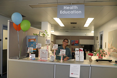 A staff person poses in the SHAC Health Promotion department.