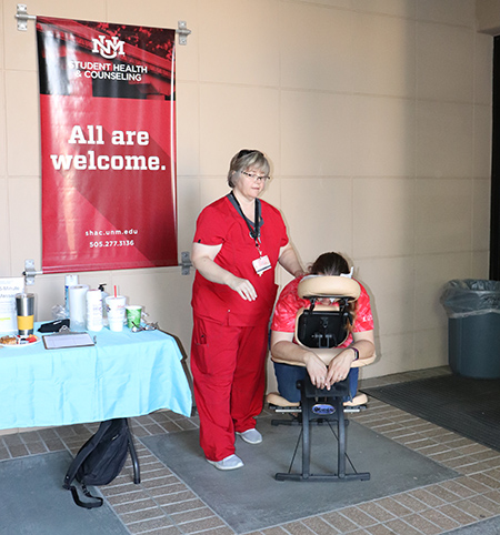 A student receives a free chair massage outside SHAC.