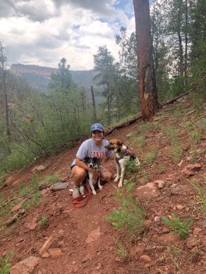 Sami Sosa poses with her two dogs in the mountains.