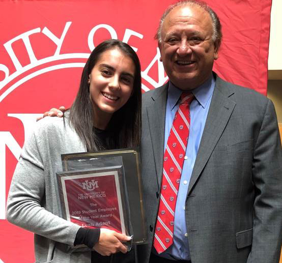 Leah Adent was photographed holding her award and standing next to Eliseo Torres, Vice President of Student Affairs.